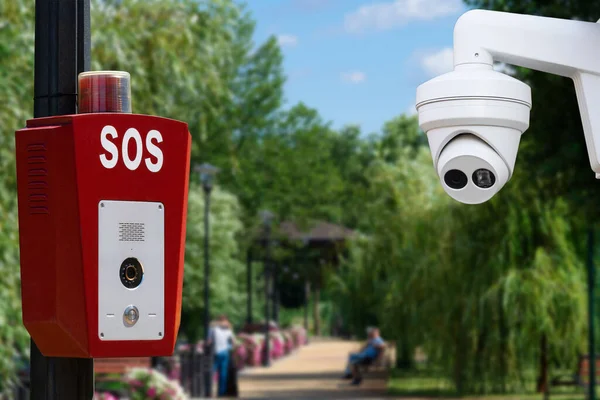 Security system in public parks. SOS, police, emergency button and security camera in a public park.