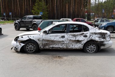war in Ukraine. Car graveyard. Cars of civilians were shot. Russias war against Ukraine. Exploded car. Cars damaged after shelling. irpin bucha. war crimes.