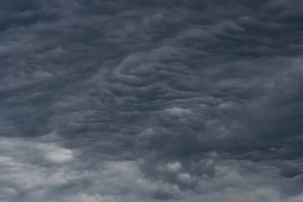 Rain clouds background. The clouds turn dark gray, like big smoke before rain