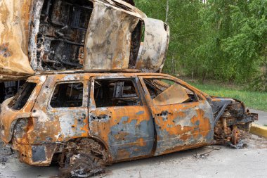 Irpin, Kyiv region, Ukraine - April 28, 2022: Car cemetery in Irpin, the consequences of the Russian army invasion of Ukraine. Destroyed cars of the civilian population.