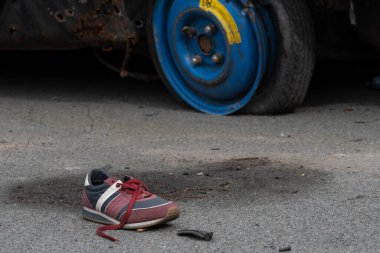 KYIV REGION, UKRAINE 05.04.2022 Irpin, Bucha, Dmitrivka. Atrocities of russian army in the suburbs Kyiv. Childrens shoes from civilian car, fired upon, burned by russian soldiers. War russia Ukraine.