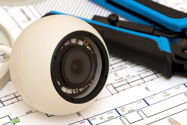 Video security equipment and blueprint on a table. Soft focus photo Good for security service engineering company site or advertising