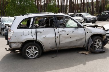 war in Ukraine. Car graveyard. Cars of civilians were shot. Russia's war against Ukraine. Exploded car. Cars damaged after shelling. irpin bucha. war crimes.