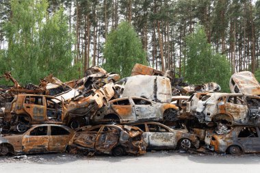 Irpin, Kyiv region, Ukraine - April 28, 2022: Car cemetery in Irpin, the consequences of the Russian army invasion of Ukraine. Destroyed cars of the civilian population.