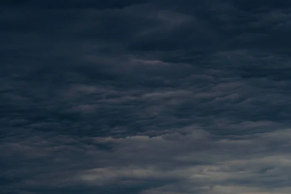 Rain clouds background. The clouds turn dark gray, like big smoke before rain