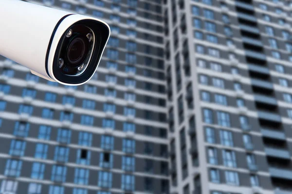 CCTV monitoring, security cameras. Backdrop with views of condominium.
