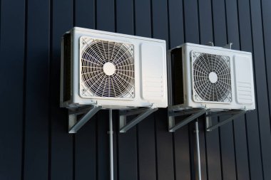Air conditioner compressor on a dark wall