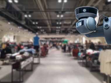 Arka planda güvenlik kamerası mağazası var..