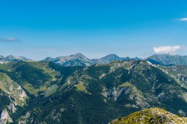 Retezat mountains from Coada Oslei hill on Oslea mountain ridge in Valcan mountains in Romania during beautiful summer morning