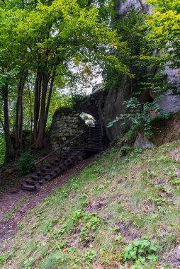 Lower part f Skaly castle ruins wuth hiking traill  near Teplice nad Metuji in Czech republic