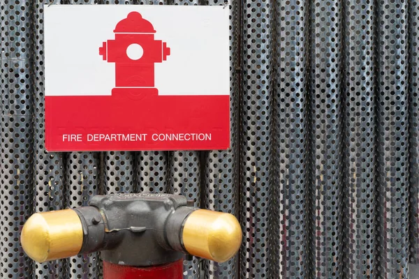 red fire hydrant icon on metal background. Fire department connection on footpath outside the building.Fire hydrant,standpipe separated for using in high zone for fire truck to connect supporting wate