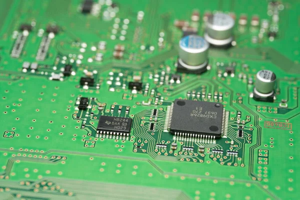 chip on green pcb board. Electronic circuit board close up.