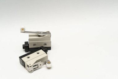 Limit switch sensor of the machine. Tiny limit switch for mechanical movement and actuators limits. isolated, white background of limit switch, control device, electrical equipment in control system.
