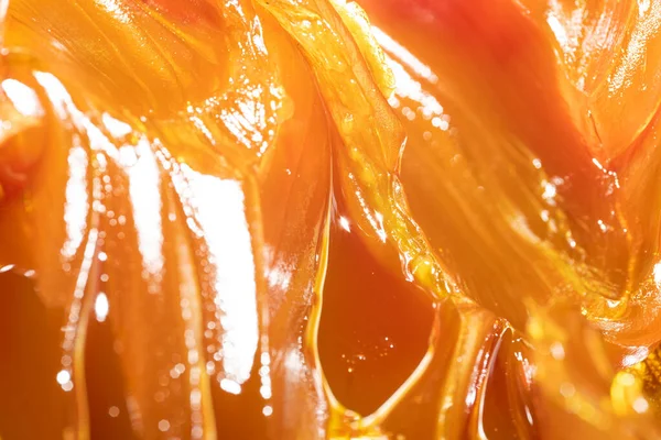 Close up of orange colored industrial grease. Rich and thick texture of industrial grade grease used to smooth out all metal friction. Lubricating grease. close-up of yellow lithium grease for machine