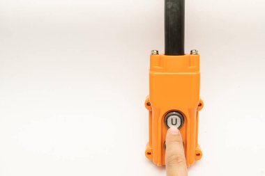 Hoist push button switch in isolated. hand holding overhead cranes remote. Up Down hydraulic controller switch. electric remote push button switch of hoist lift or crane for control direction.