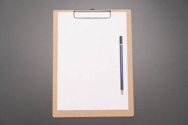 a clipboard with a white sheet of paper