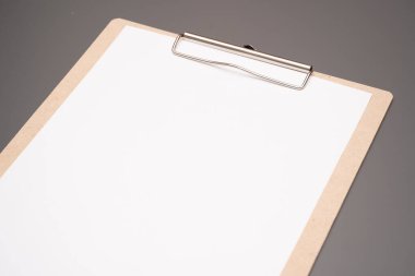 a clipboard with a white sheet of paper