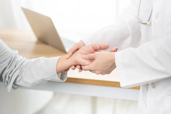 Female doctor using hand to checking the pulse. Doctor checking patient\'s pulse.