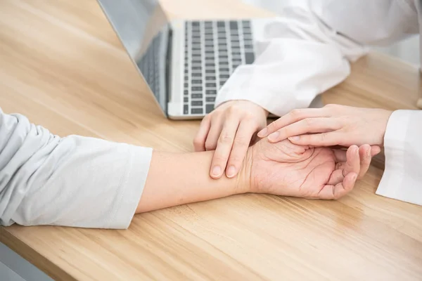 Female doctor using hand to checking the pulse. Doctor checking patient\'s pulse.