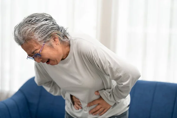 Senior Woman Suffering Stomach Ache Home Grabbing Squeezing Belly Hand — Stock Photo, Image