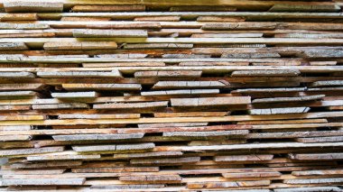 Many wooden boards with different textures stuck up on each other 