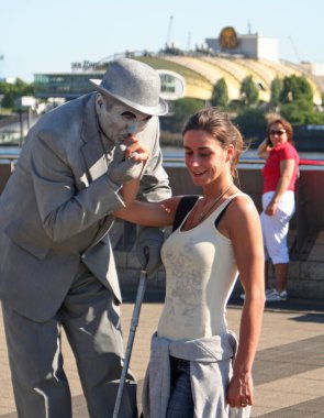 Hamburg limanında birçok eğlence vardır. Bir mumyacı genç bir kadınla flört ediyor..