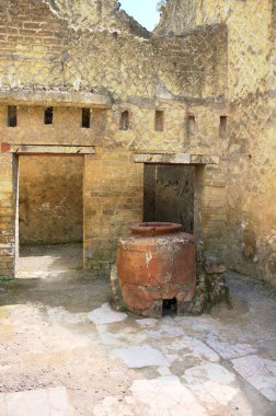 Herculaneum was an ancient city on the Gulf of Naples that sank like Pompeii, Stabiae and Oplontis during the eruption of Vesuvius in the second half of the year 79.This photo shows a house entrance with a large clay jug clipart
