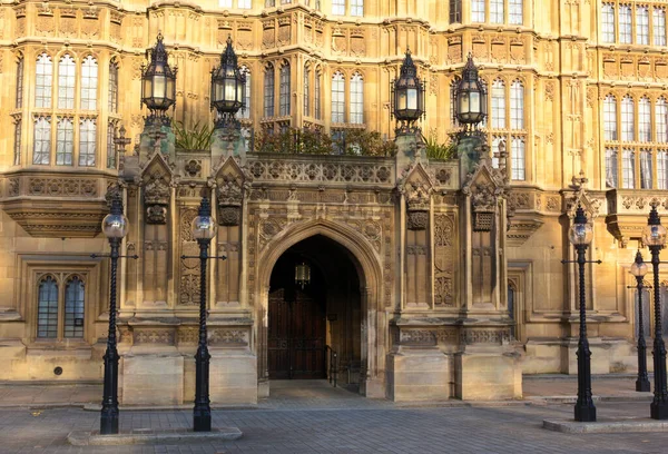 The Palace of Westminster serves as the meeting place of the House of Commons and the House of Lords, the two houses of the Parliament of the United Kingdom. This photo shows an rich ornamented entrance.