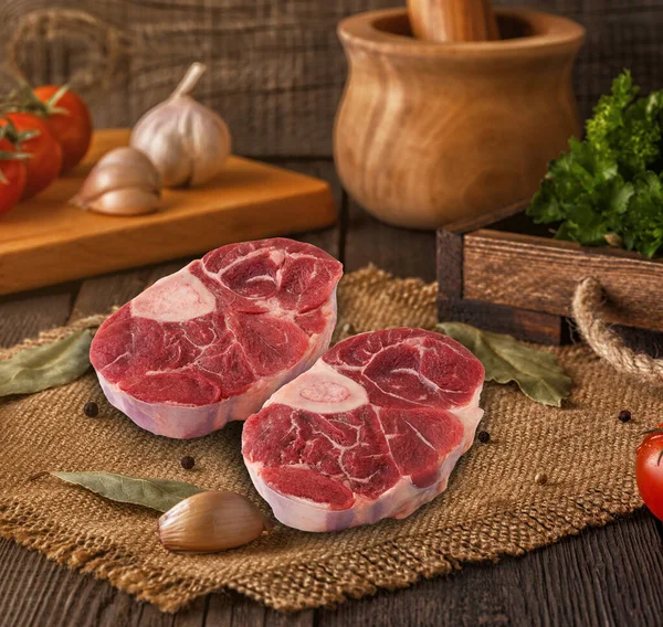 fresh and raw meat beef shank on the wooden cutting board.
