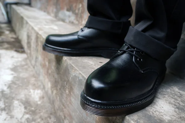 Solid black 3 hole boots handmade by home craftsman with rubber sole men wearing black pants for outdoor hangout