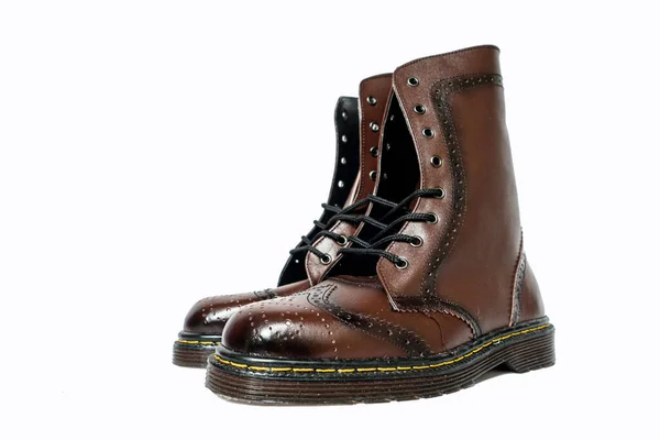 This dark brown 8-hole brogue wingtip boot made of genuine leather was photographed on a white background