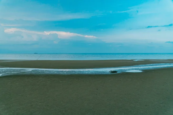 Black sand beach in Talisayan, East Kalimantan which is receding, the waves are relatively calm and the sky is cloudy