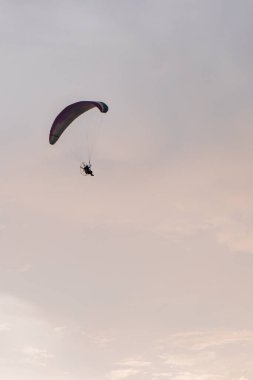 Powered parachute always adorns the sky of Parangtritis beach, Yogyakarta, Indonesia when the evening until the sun goes down, becoming an interesting spectacle for visiting tourists.