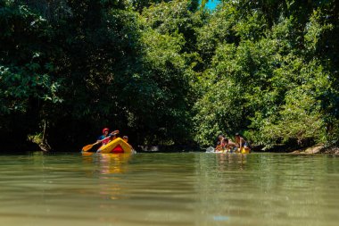 Playing rubber boats and tubing on the river with local children in a river that is still beautiful and lush in the interior of Kalimantan is so much fun