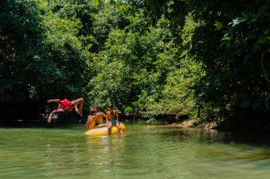 Playing rubber boats and tubing on the river with local children in a river that is still beautiful and lush in the interior of Kalimantan is so much fun