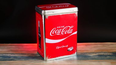 Vintage Coca-Cola Storage Tin on Black Background backlit with red light and vibrant colours
