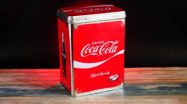 Vintage Coca-Cola Storage Tin on Black Background with red accents and bright lighting