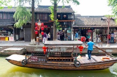 Şangay, Çin - Eylül 2019: Çin 'in Qingpu Bölgesi' nde tarihi bir köy ve ünlü bir turizm beldesi olan Zhujiajiao Antik Su Kasabası 'ndaki kanal boyunca geleneksel Çin kayığıyla gezi turu