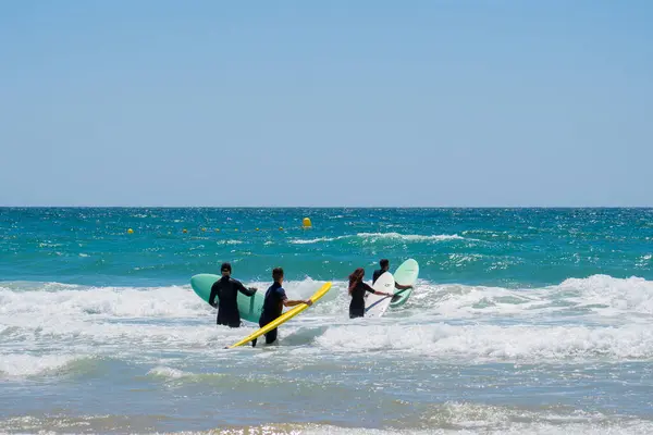 surfers in the water surfing