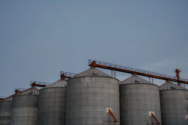 silos outside the city with the blue sky in the background