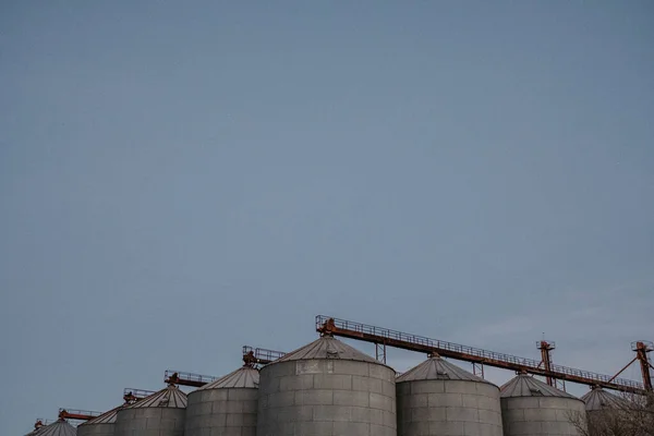 silos outside the city with the blue sky in the background