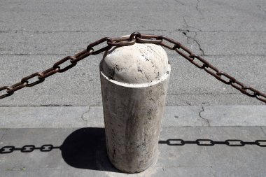 Fencing along the road to separate the carriageway from the sidewalk. 