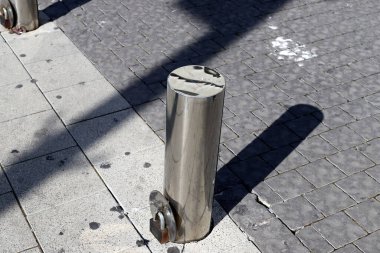 Fencing along the road to separate the carriageway from the sidewalk. 