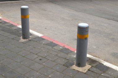 Fencing along the road to separate the carriageway from the sidewalk. 