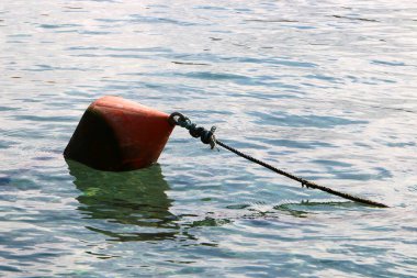 A rope with floats on the city beach enclosing safe swimming areas. 