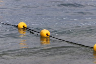 A rope with floats on the city beach enclosing safe swimming areas. 