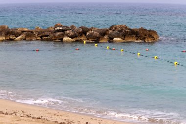 A rope with floats on the city beach enclosing safe swimming areas. 