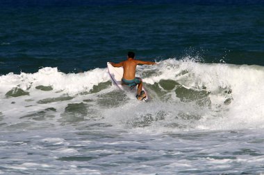 Surfing on high waves in the Mediterranean.