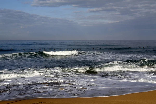 Surfing on high waves in the Mediterranean.
