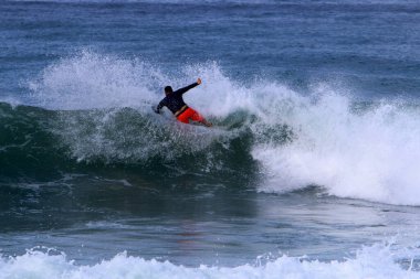 Surfing on high waves in the Mediterranean.